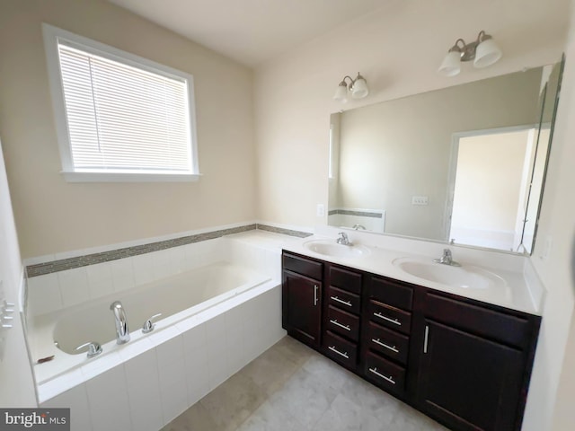 full bath featuring double vanity, tile patterned flooring, a sink, and a garden tub