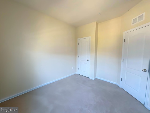 unfurnished bedroom featuring baseboards and visible vents