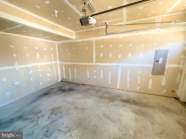 garage with a garage door opener and electric panel