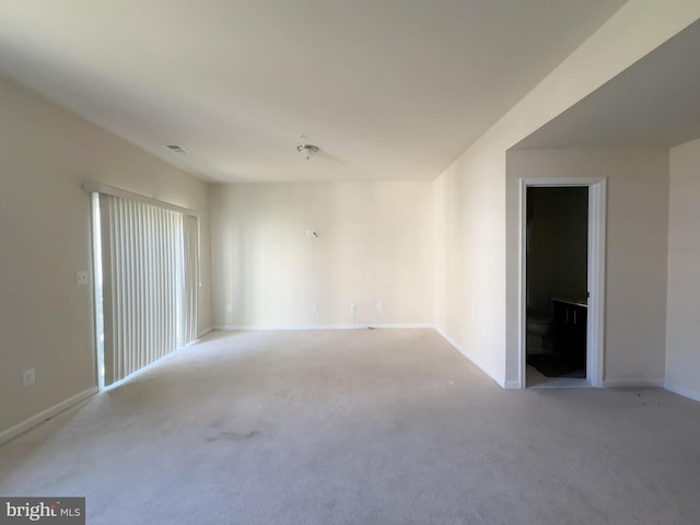 empty room with light carpet, baseboards, and visible vents