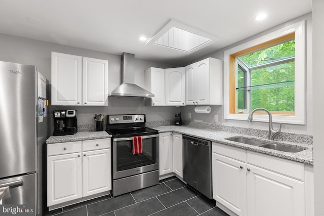 6266 Occoquan Forest Dr, Manassas, VA 20112 - kitchen featuring appliances with stainless steel finishes, wall chimney exhaust hood, a sink, dark tile patterned floors, and white cabinets
