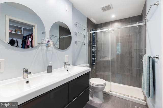 6266 Occoquan Forest Dr, Manassas, VA 20112 - bathroom featuring toilet, a shower stall, double vanity, and a walk in closet