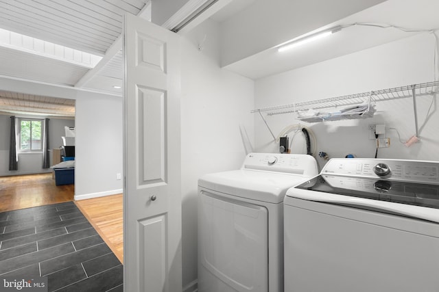 6266 Occoquan Forest Dr, Manassas, VA 20112 - washroom featuring washing machine and dryer and dark wood-style flooring