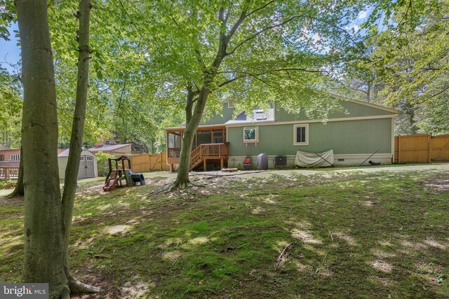 6266 Occoquan Forest Dr, Manassas, VA 20112 - rear view of property with a storage shed, a sunroom, an outdoor structure, crawl space, and fence