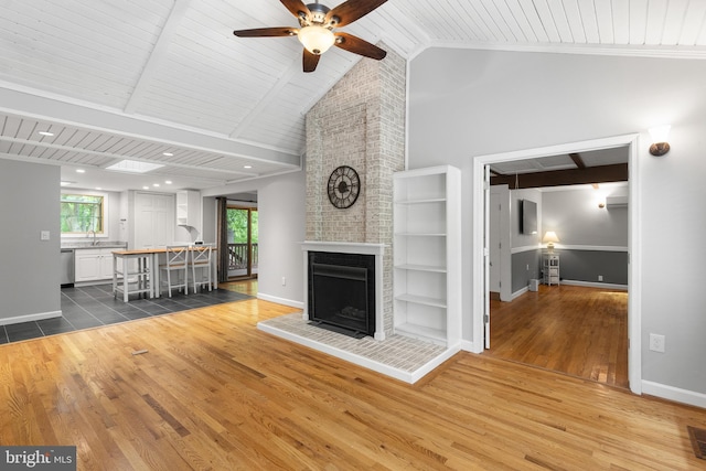 6266 Occoquan Forest Dr, Manassas, VA 20112 - living area featuring a ceiling fan, wood finished floors, baseboards, a brick fireplace, and wooden ceiling