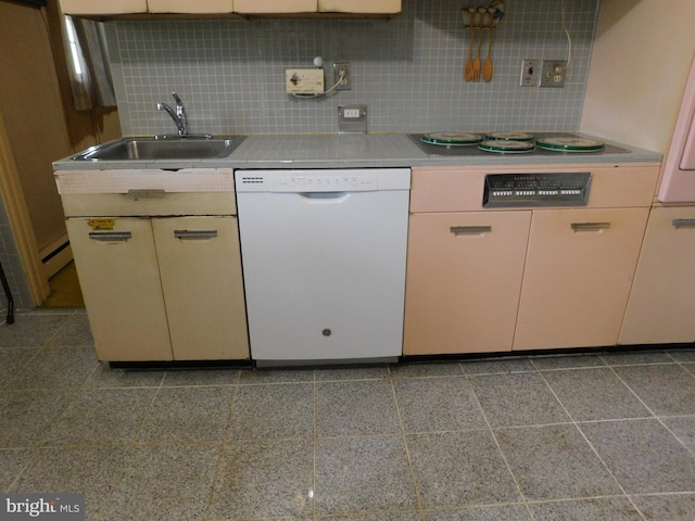 kitchen featuring a sink, electric cooktop, backsplash, white dishwasher, and light countertops