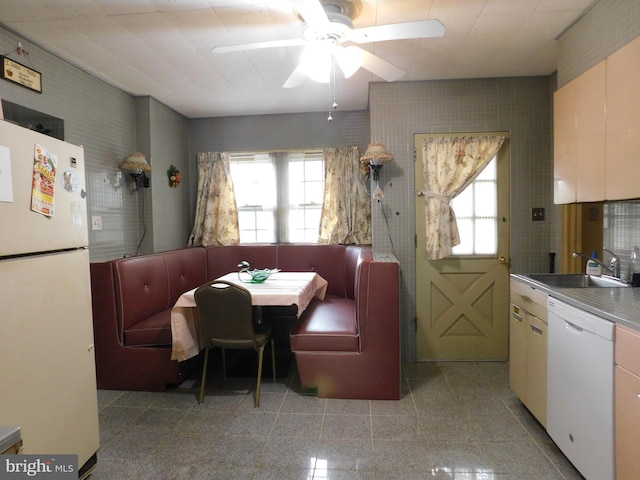 dining area featuring a ceiling fan and granite finish floor