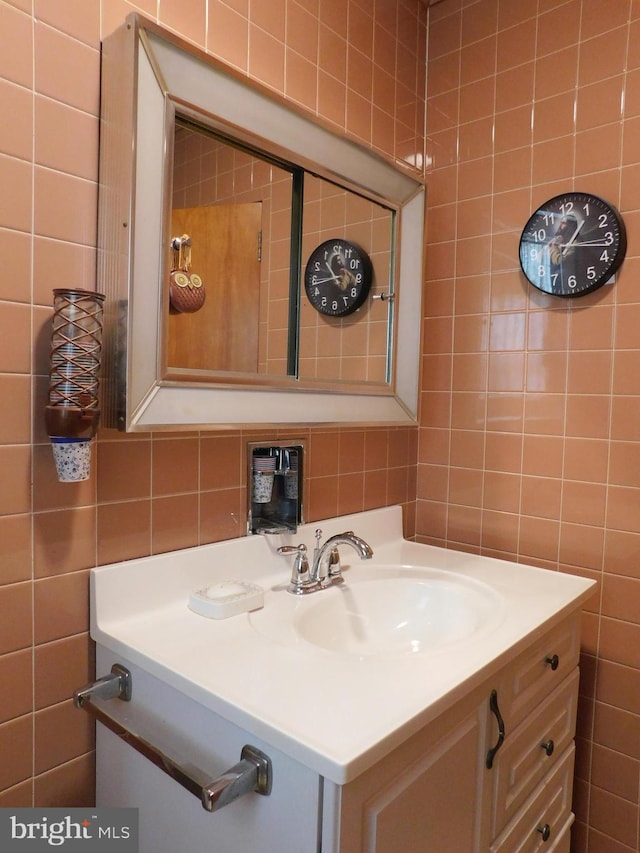 bathroom with tile walls and vanity