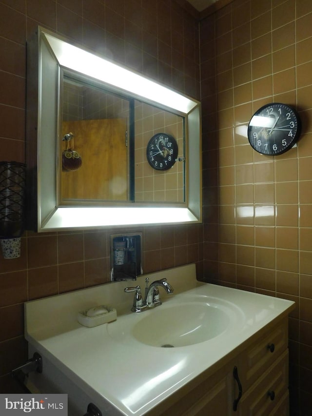 bathroom featuring tile walls, vanity, and decorative backsplash