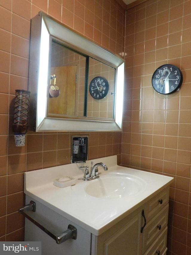 bathroom with tile walls and vanity