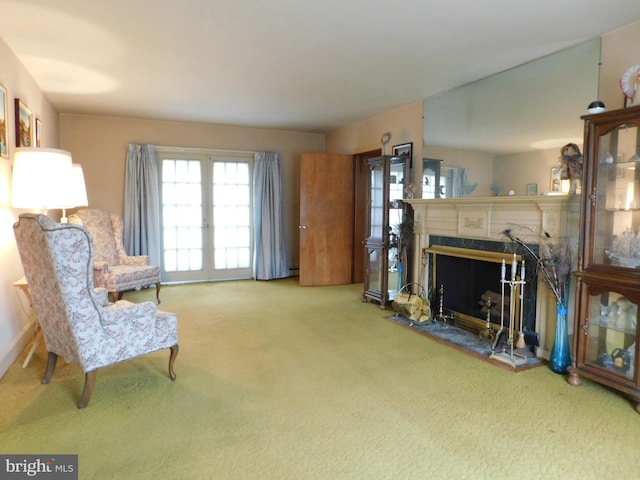 sitting room with a premium fireplace and carpet