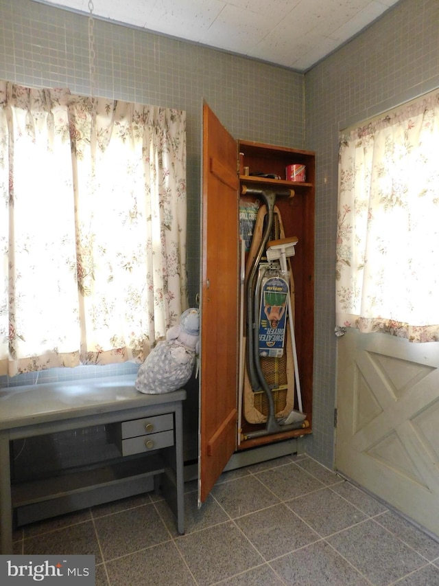 bedroom with multiple windows and a closet