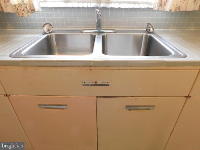 room details with light countertops and tasteful backsplash