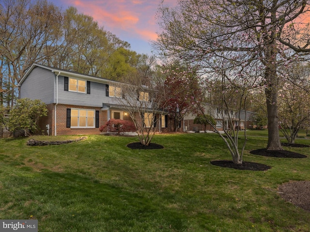 666 Clifton Dr, Bear, DE 19701 - traditional-style home with a front lawn and brick siding