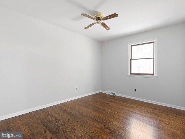 666 Clifton Dr, Bear, DE 19701 - empty room featuring visible vents, a ceiling fan, baseboards, and dark wood-style flooring