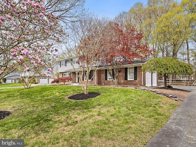 666 Clifton Dr, Bear, DE 19701 - view of front of home with brick siding, a garage, a front yard, and fence