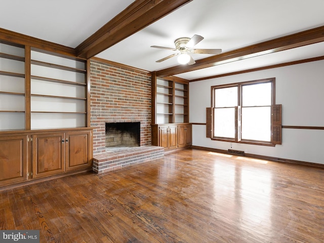 666 Clifton Dr, Bear, DE 19701 - unfurnished living room featuring beam ceiling, a ceiling fan, a brick fireplace, wood finished floors, and crown molding