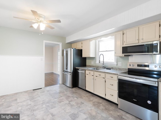 666 Clifton Dr, Bear, DE 19701 - kitchen with a sink, visible vents, a ceiling fan, appliances with stainless steel finishes, and cream cabinets
