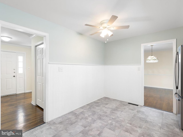 666 Clifton Dr, Bear, DE 19701 - unfurnished room featuring wainscoting, plenty of natural light, a ceiling fan, and visible vents