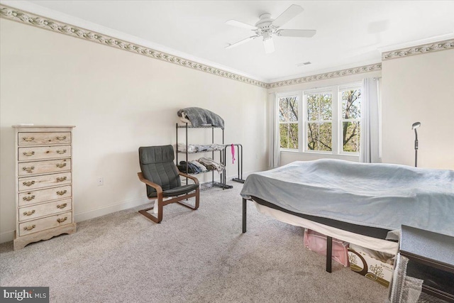 carpeted bedroom with baseboards, ornamental molding, and ceiling fan