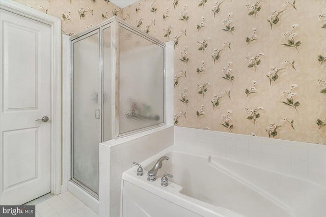 bathroom with tile patterned floors, a shower stall, wallpapered walls, and a garden tub