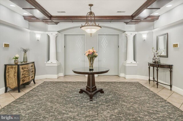 interior space featuring coffered ceiling, ornate columns, and visible vents