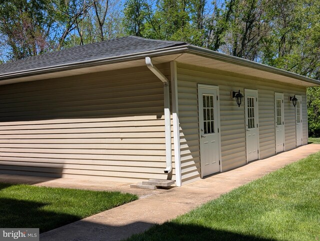 view of side of home featuring a shingled roof