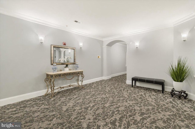 interior space featuring ornamental molding, decorative columns, carpet flooring, and visible vents