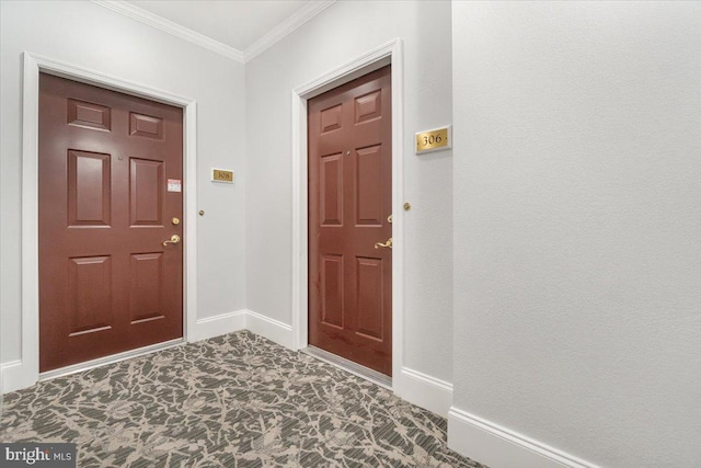 foyer entrance with baseboards and ornamental molding