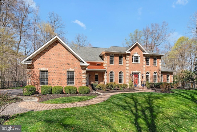 view of front of property with a front lawn and brick siding