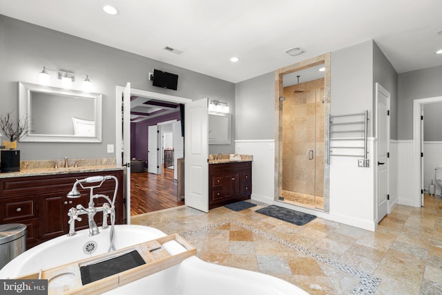 bathroom featuring visible vents, a stall shower, recessed lighting, and wainscoting