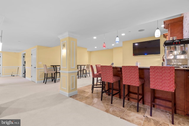 bar with recessed lighting, wet bar, hanging light fixtures, a decorative wall, and light carpet
