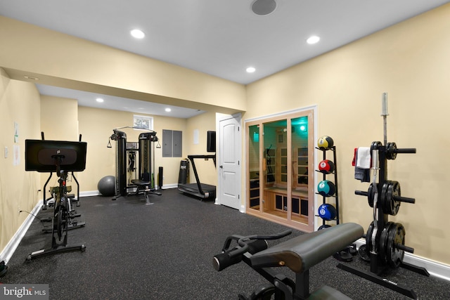 workout area with electric panel, baseboards, and recessed lighting