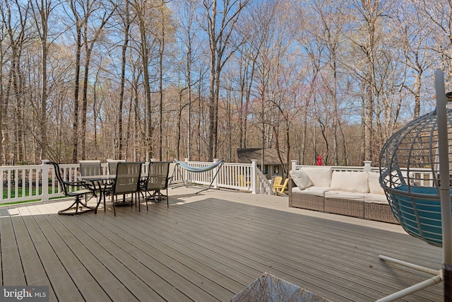 wooden deck featuring an outdoor hangout area and outdoor dining space
