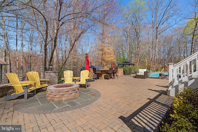 view of patio featuring a fire pit and outdoor dining area