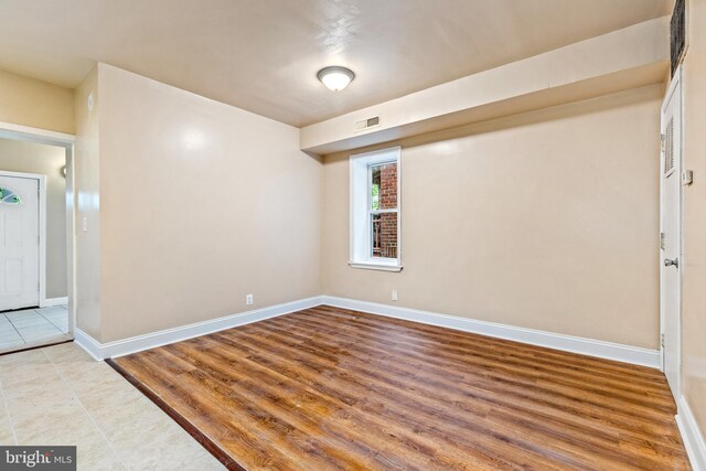 1508 V St SE, Washington, DC 20020 - spare room with wood finished floors, baseboards, and visible vents