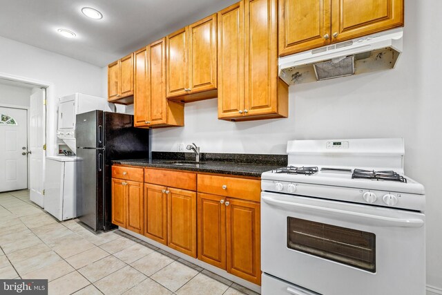 1508 V St SE, Washington, DC 20020 - kitchen featuring freestanding refrigerator, white gas range oven, washer / clothes dryer, under cabinet range hood, and a sink
