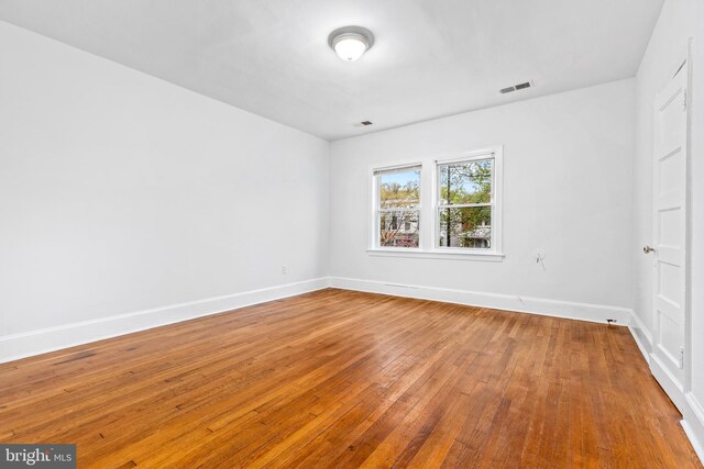 1508 V St SE, Washington, DC 20020 - empty room featuring visible vents, baseboards, and hardwood / wood-style flooring