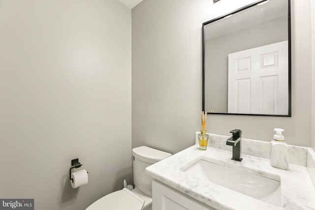 bathroom featuring toilet and vanity