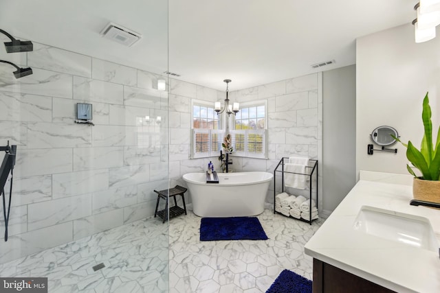 full bath with a freestanding tub, double vanity, a walk in shower, visible vents, and a sink