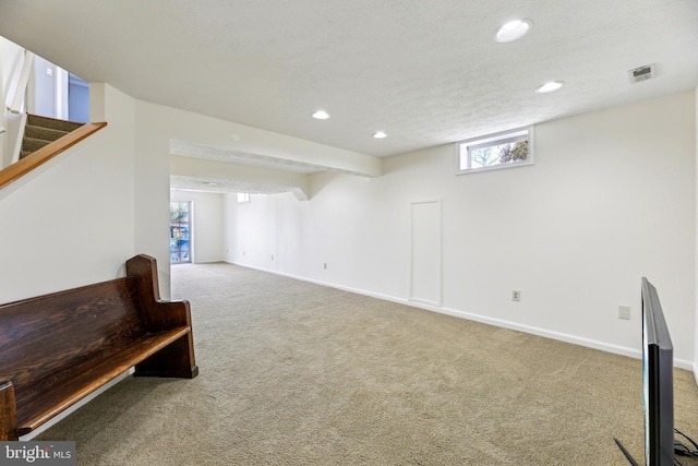basement featuring baseboards, carpet, and recessed lighting