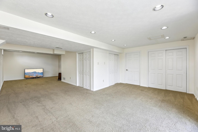 finished below grade area with carpet floors, baseboards, and recessed lighting