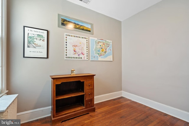 interior details with baseboards and wood finished floors