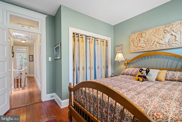 bedroom featuring baseboards and hardwood / wood-style floors