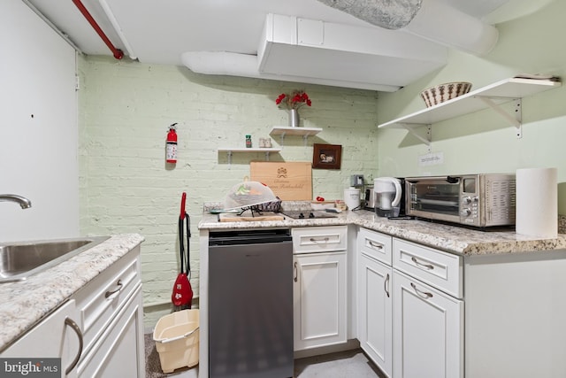 kitchen with open shelves, a toaster, refrigerator, white cabinetry, and a sink