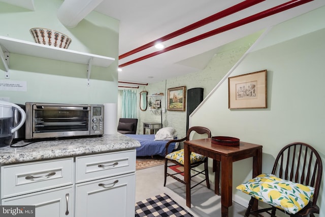 kitchen featuring white cabinetry and a toaster