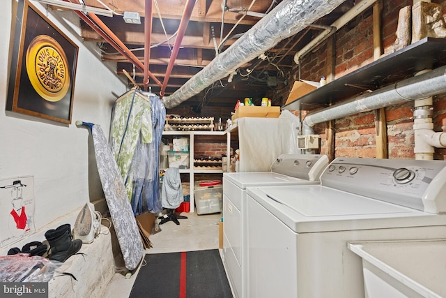 washroom with laundry area, a sink, and washer and dryer