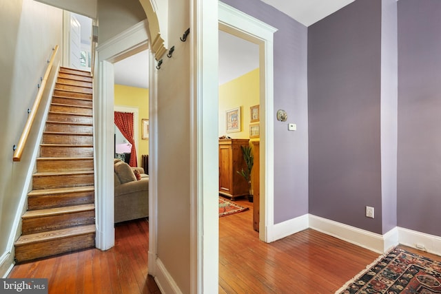 stairway with baseboards and hardwood / wood-style flooring
