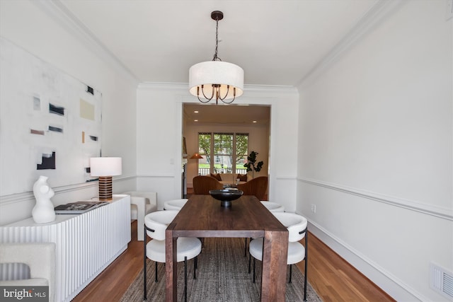979 Powhatan St, Alexandria, VA 22314 - dining room featuring visible vents, crown molding, wood finished floors, and a notable chandelier