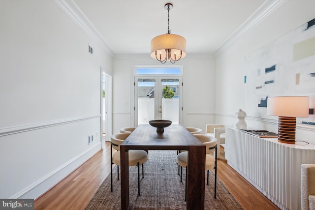 979 Powhatan St, Alexandria, VA 22314 - dining area featuring french doors, an inviting chandelier, ornamental molding, and wood finished floors